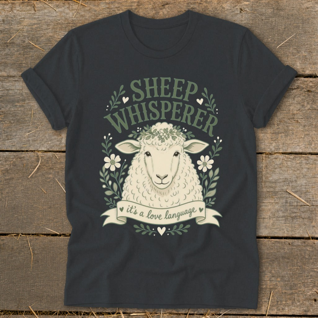 Dark grey t-shirt with a sheep illustration and text reading "Sheep Whisperer, it's a love language."