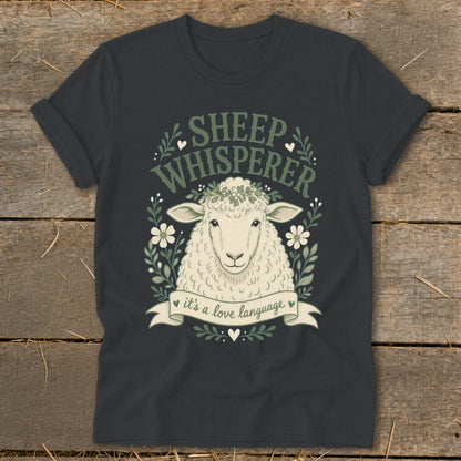 Dark grey t-shirt with a sheep illustration and text reading "Sheep Whisperer, it's a love language."