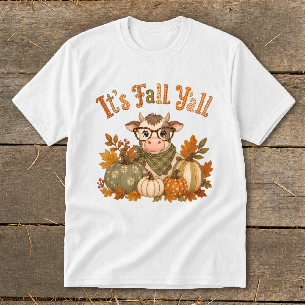 Cow with glasses and pumpkins graphic with "It's Fall Y'all" text on white t-shirt.