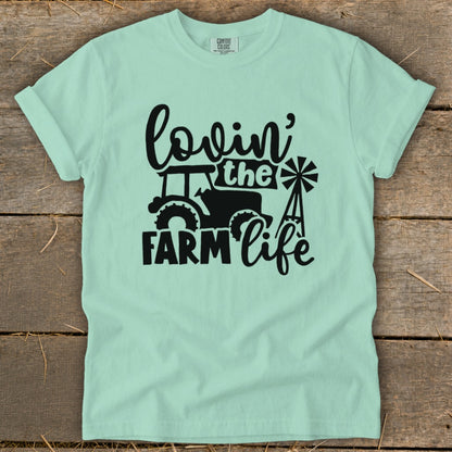 Light mint green t-shirt with black "Lovin' the Farm Life" graphic and tractor.