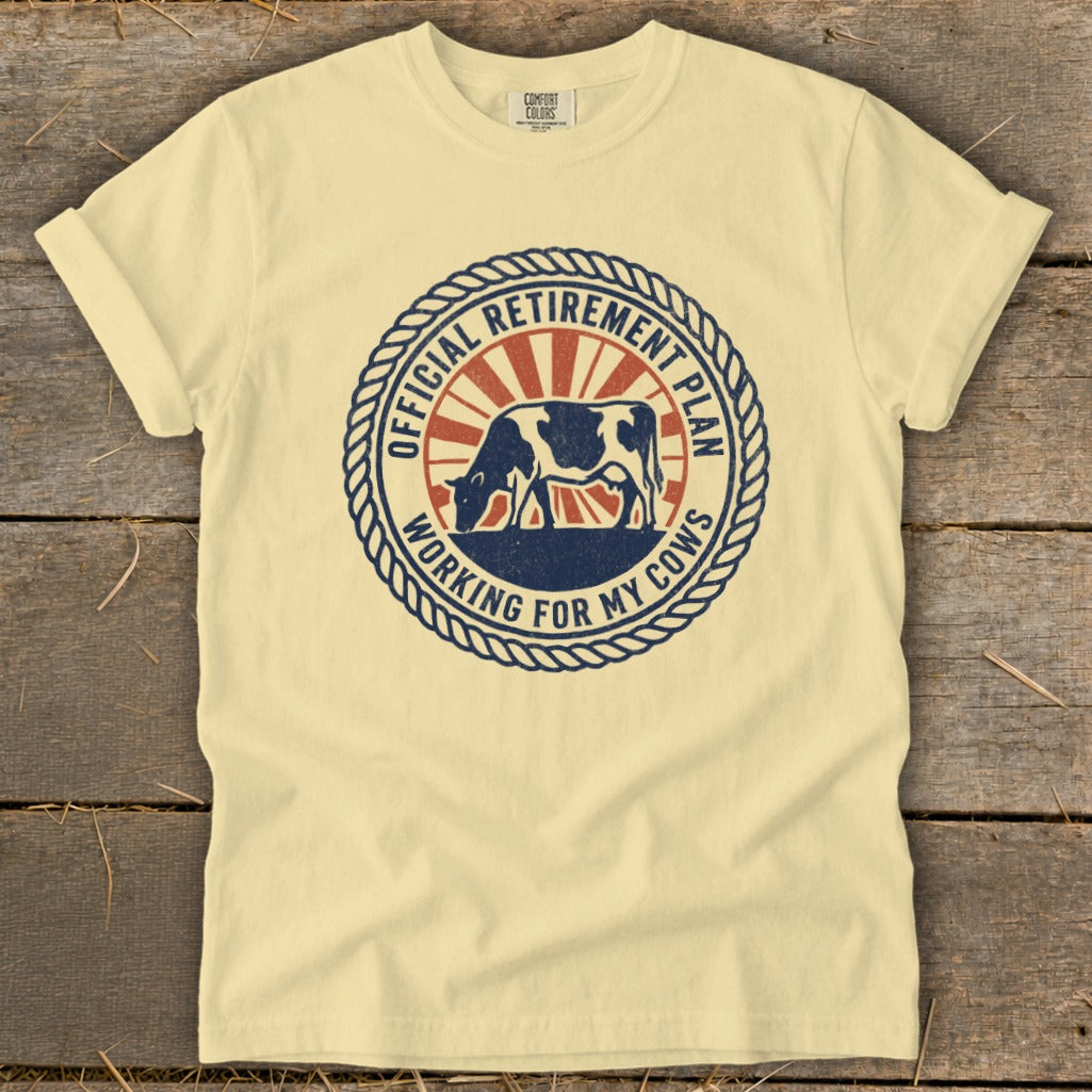 Cream t-shirt with round graphic: "Official Retirement Plan Working for My Cows" and cow.
