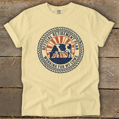 Cream t-shirt with round graphic: "Official Retirement Plan Working for My Cows" and cow.