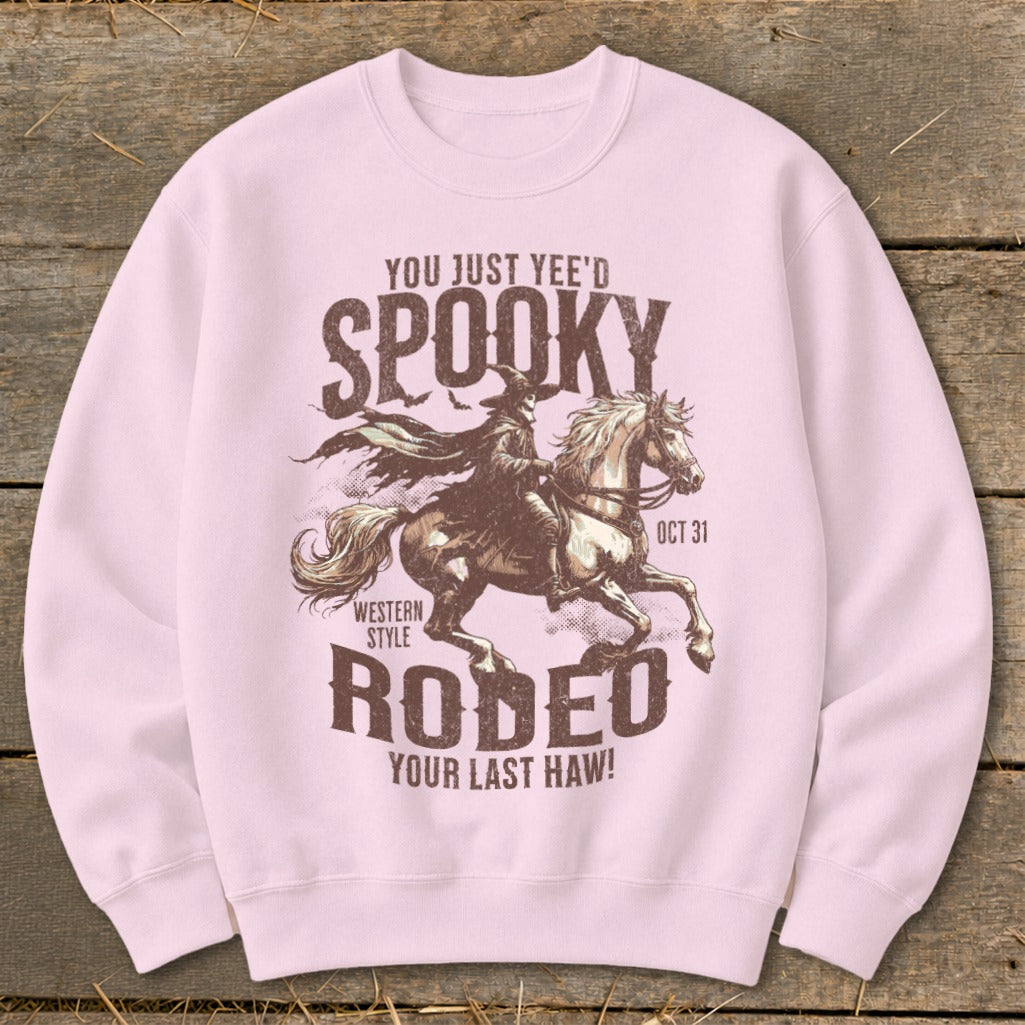 Light pink sweatshirt with spooky rodeo graphic and text.
