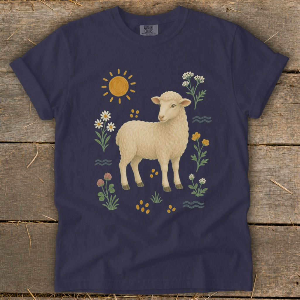 Navy t-shirt with a fluffy sheep surrounded by flowers, sun, and waves.
