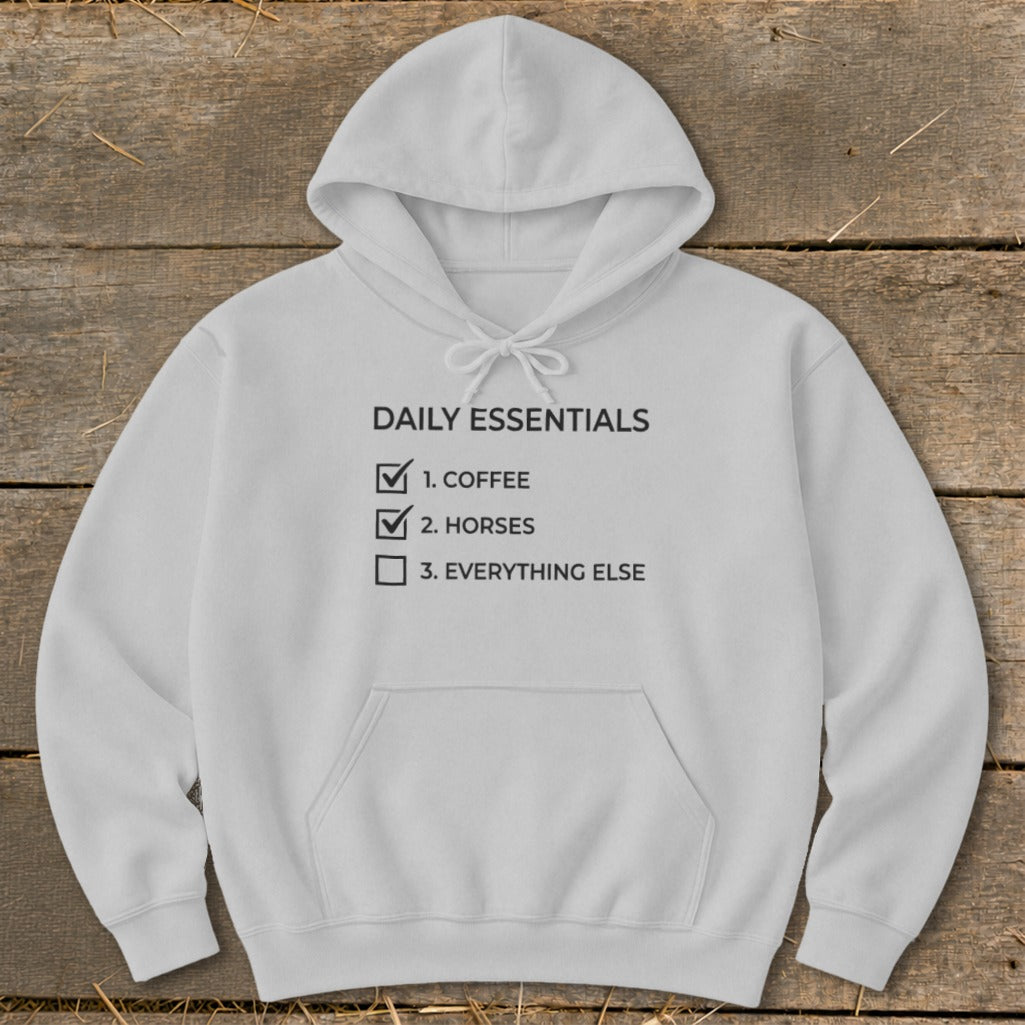 White hoodie with "Daily Essentials" list: coffee, horses, and everything else.