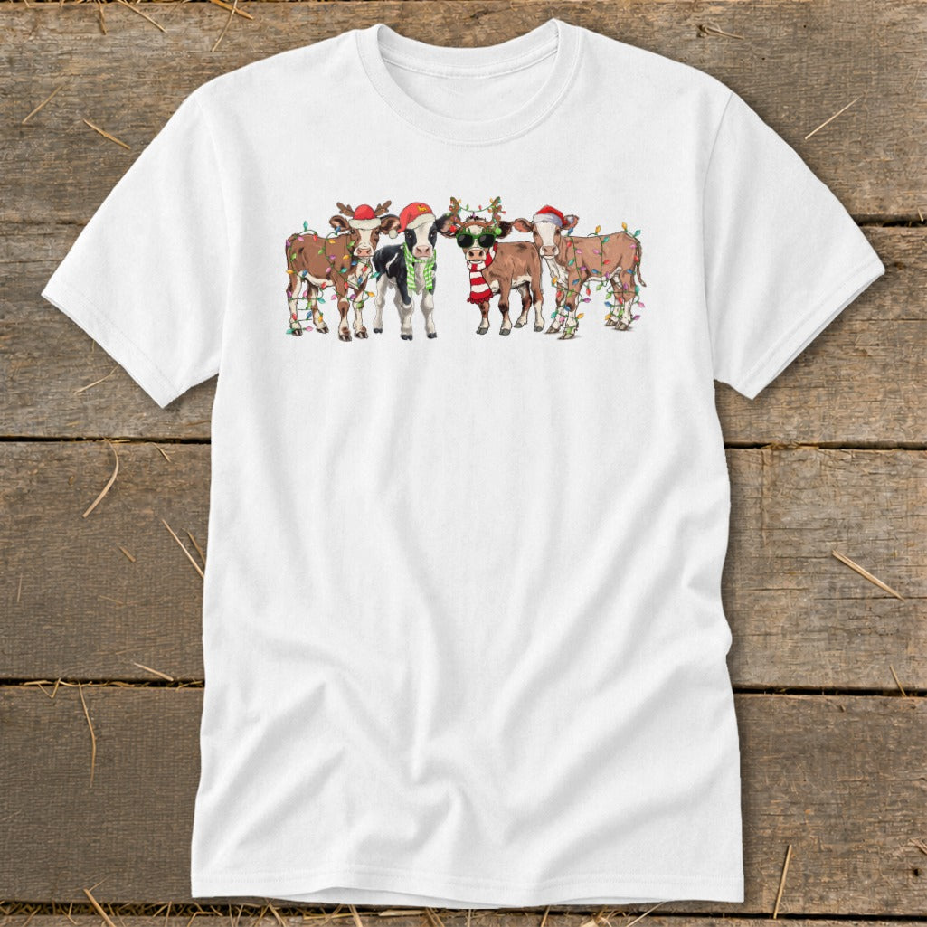 Five cartoon cows wearing Santa hats and Christmas lights.