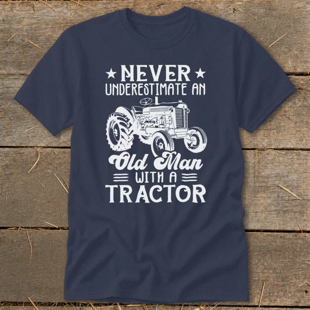 Navy t-shirt with graphic of a tractor and text "Never Underestimate an Old Man With a Tractor".