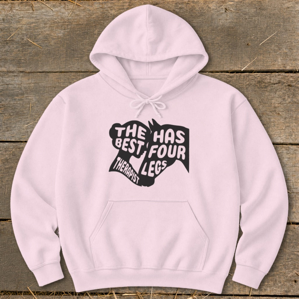 Light pink hoodie with black text and horse head graphic reading "The Therapist Has Best Four Legs".