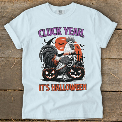 T-shirt with skeleton rooster, pumpkins, and bats, saying "CLUCK YEAH, IT'S HALLOWEEN."