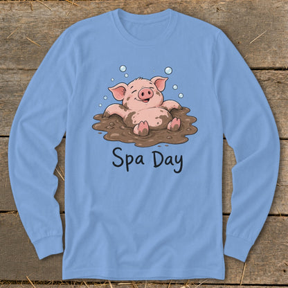 Light blue long-sleeve shirt with cartoon pig enjoying mud bath and text "Spa Day".