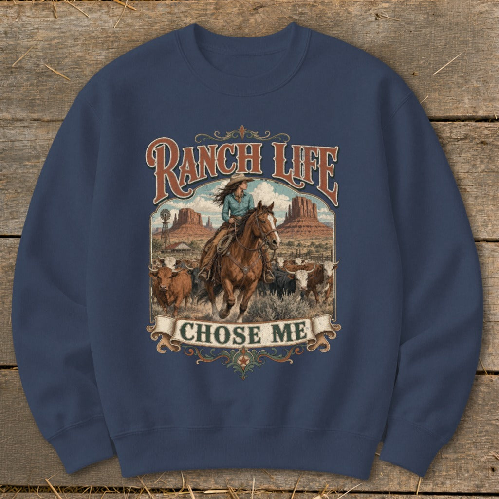 Ranch Life Chose Me graphic on a navy blue sweatshirt with a cowboy riding a horse and cattle.