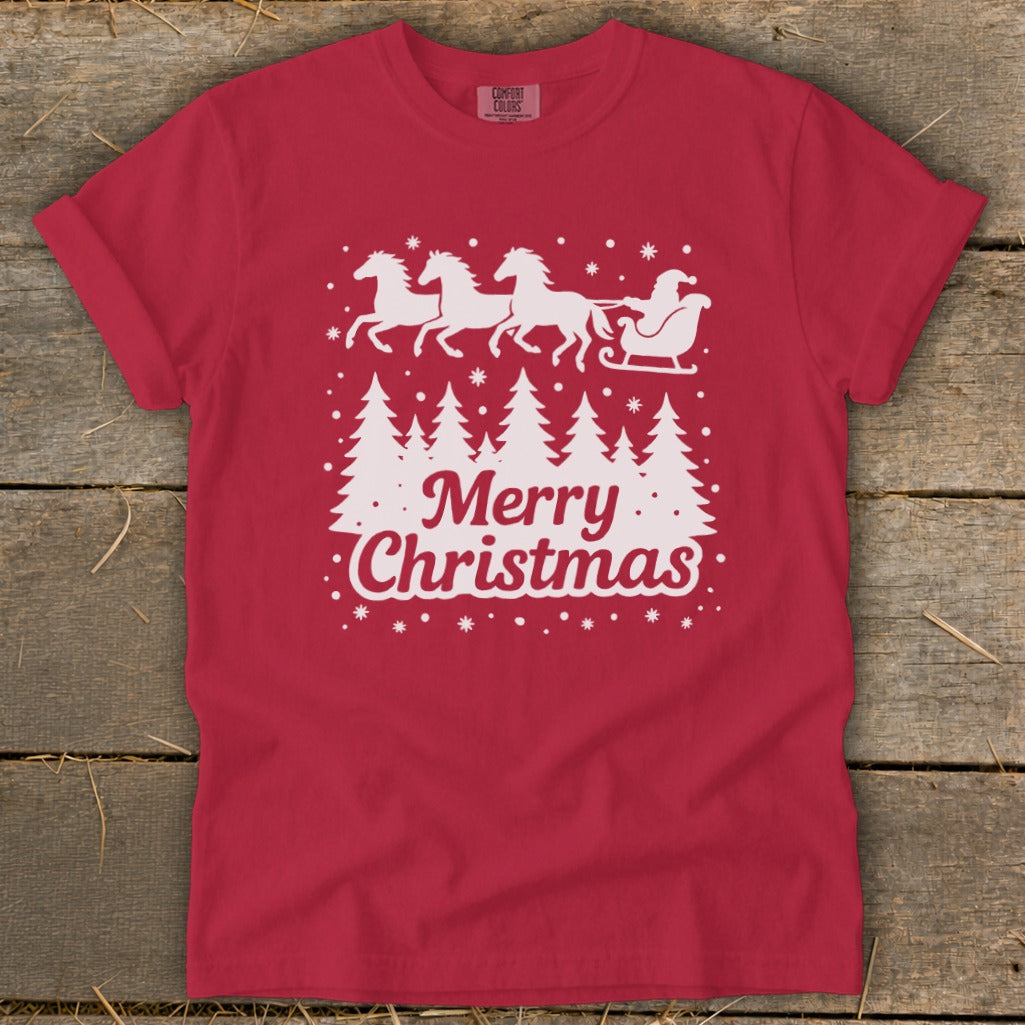 Red t-shirt with white graphic of horses pulling Santa's sleigh above trees and "Merry Christmas".