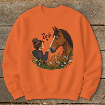 Girl booping horse with text "Boop" and wildflowers.
