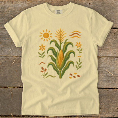 Light yellow t-shirt with a central corn stalk design and surrounding floral and sun elements.