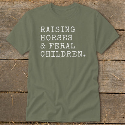 Olive green t-shirt with white text "RAISING HORSES & FERAL CHILDREN."