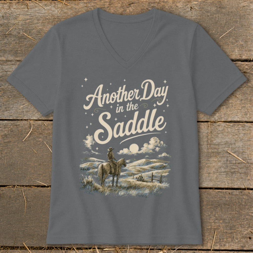 Gray t-shirt with "Another Day in the Saddle" text and cowboy on horseback graphic.
