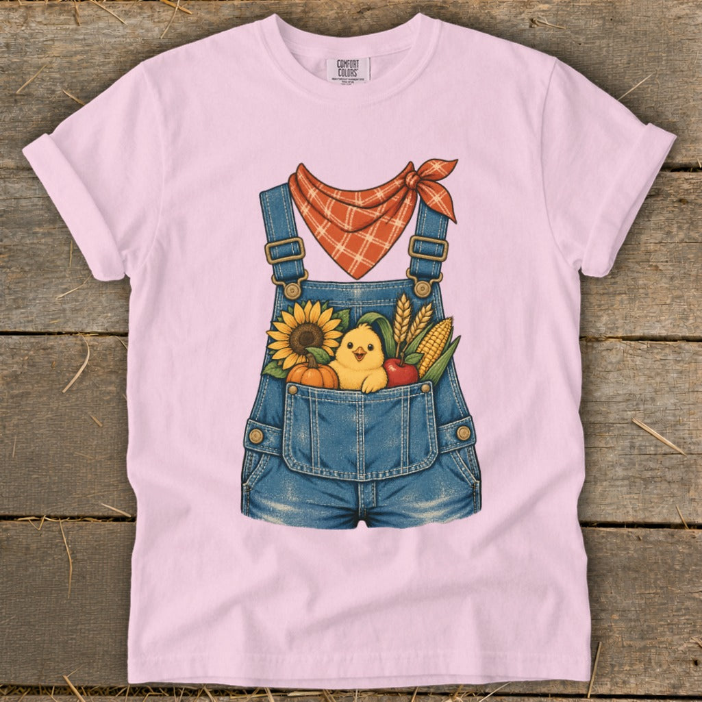 Pink t-shirt with denim overalls graphic featuring a chick, sunflower, pumpkin, apple, and corn.