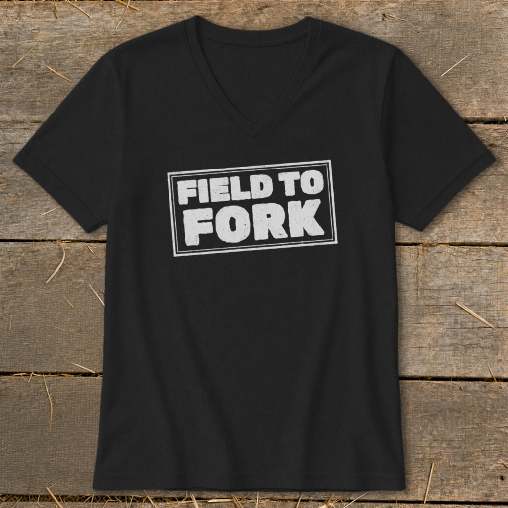 A black V-neck t-shirt with a white distressed box graphic featuring the text Field to Fork.