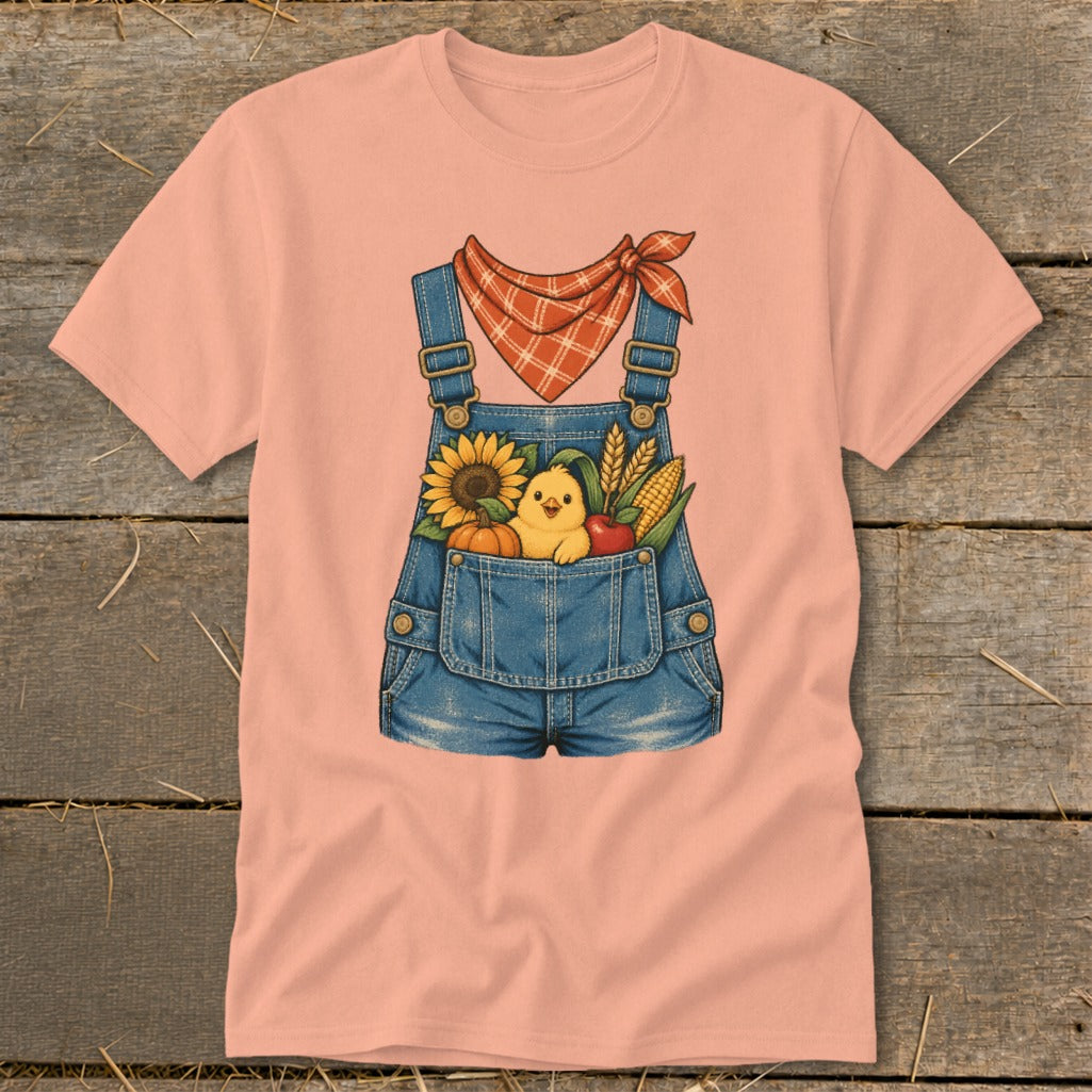 Peach t-shirt with denim overalls graphic featuring a chick, sunflower, pumpkin, apple, and corn.