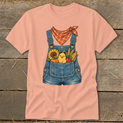 Peach t-shirt with denim overalls graphic featuring a chick, sunflower, pumpkin, apple, and corn.