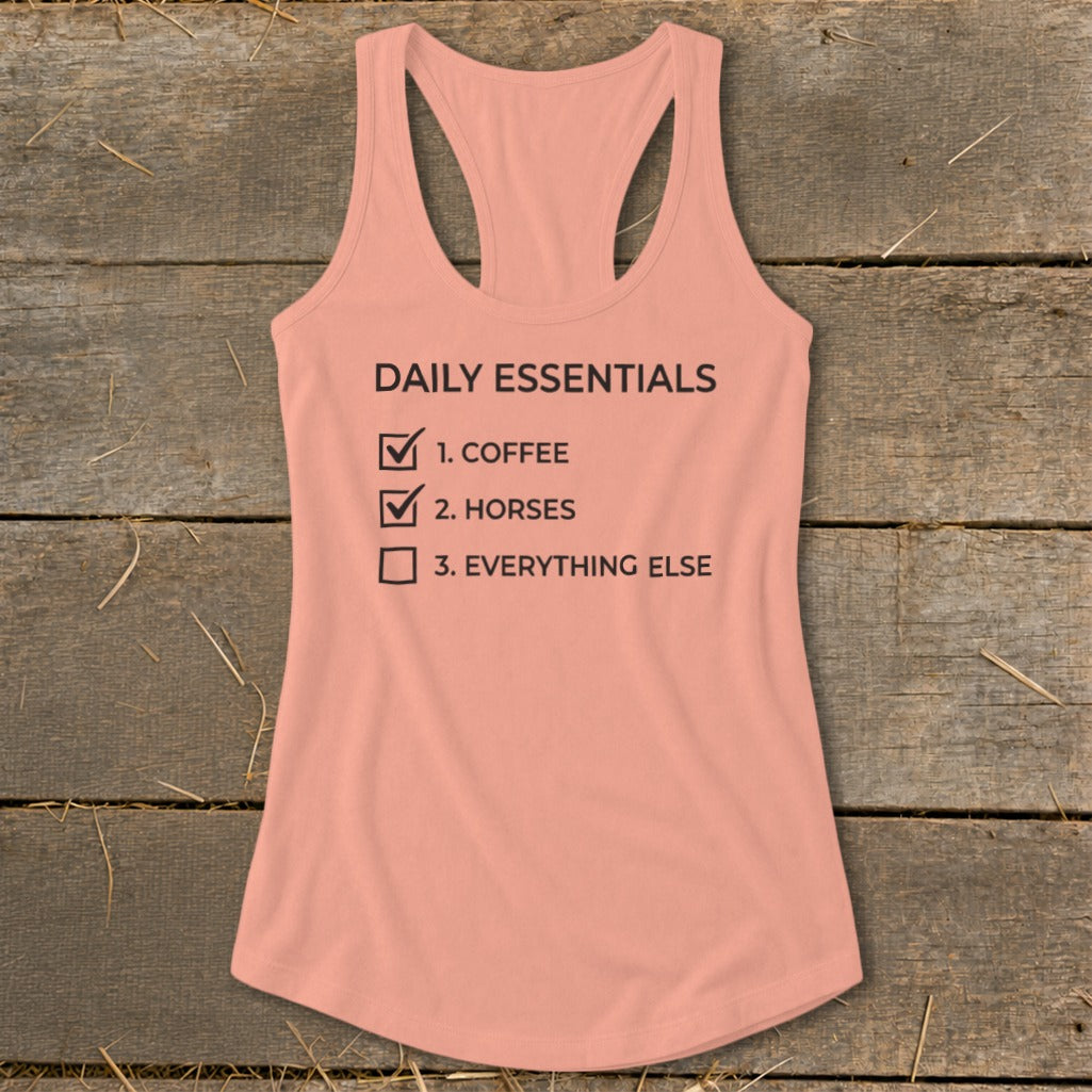 Peach tank top with "Daily Essentials" checklist: coffee, horses, everything else.