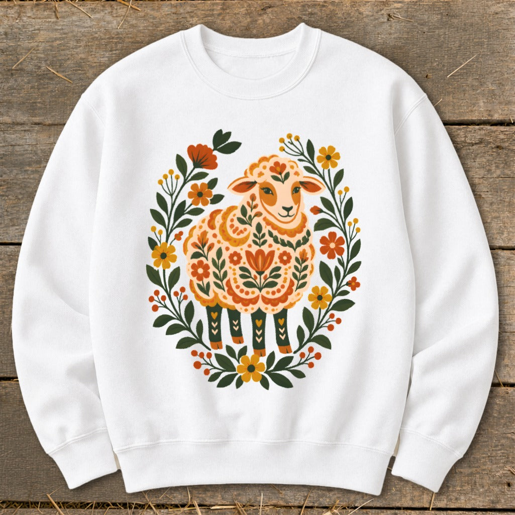 White sweatshirt with a sheep design surrounded by a floral wreath.