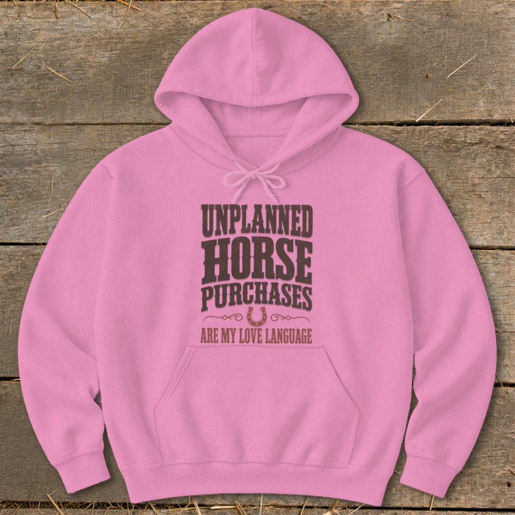 Pink hoodie with "Unplanned Horse Purchases Are My Love Language" text and horseshoe graphic.