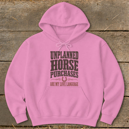 Pink hoodie with "Unplanned Horse Purchases Are My Love Language" text and horseshoe graphic.