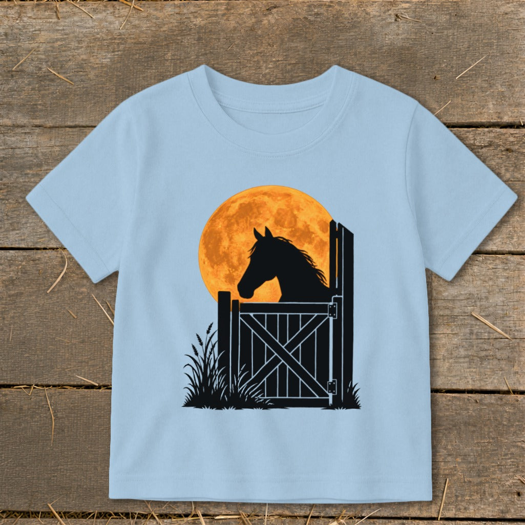 Light blue short-sleeved t-shirt featuring a graphic of a horse silhouette looking over a gate against a full moon.