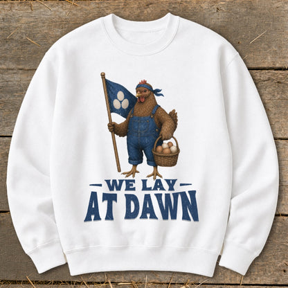 Chicken in overalls holds flag and egg basket, text reads "WE LAY AT DAWN".
