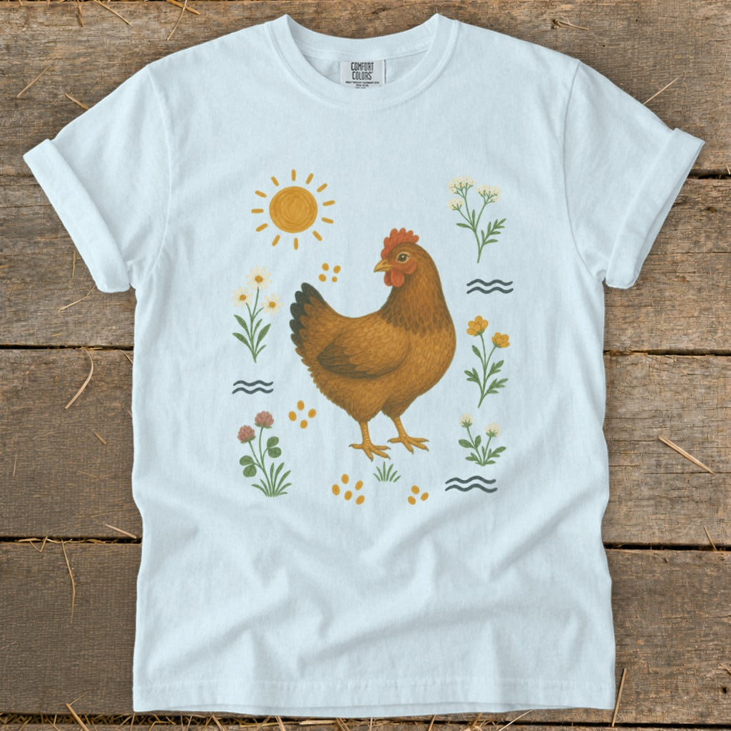 White t-shirt with a brown chicken and floral graphic, sun, and wavy lines.