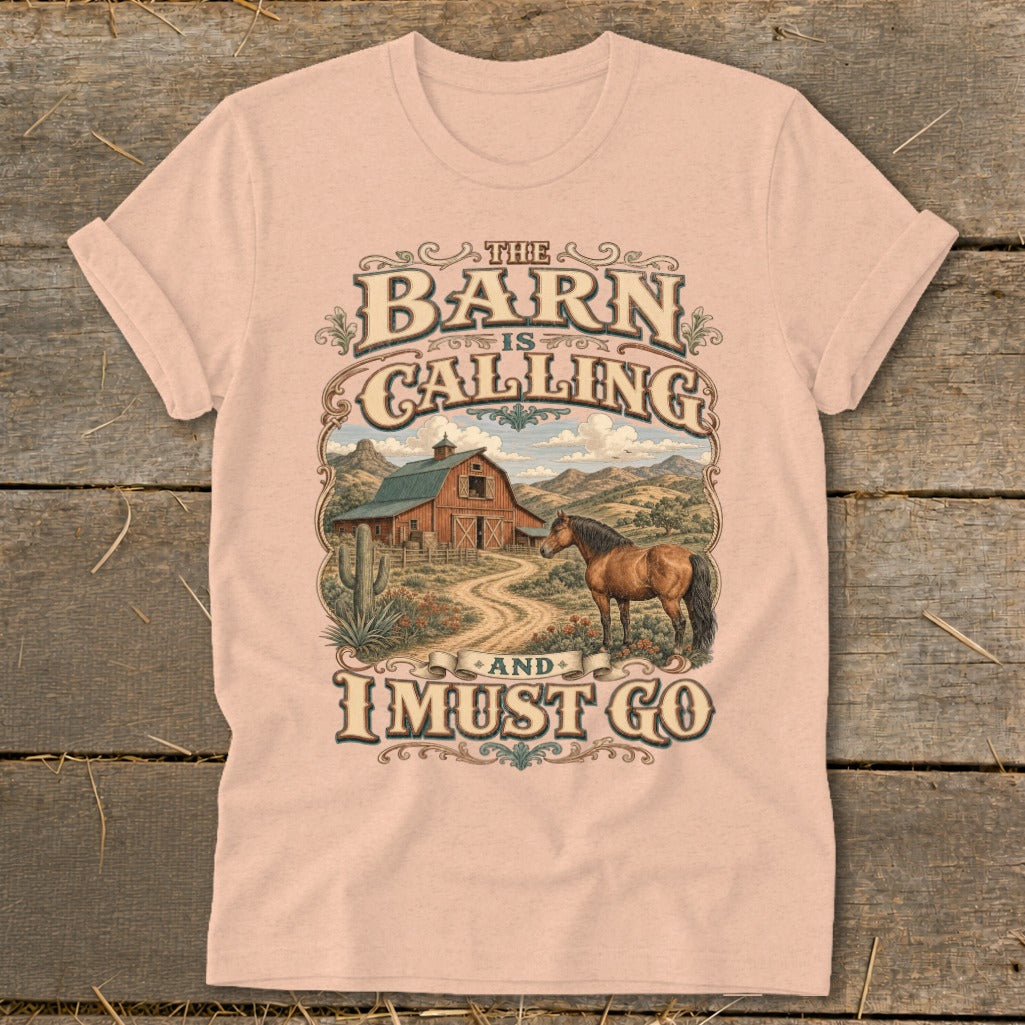 Peach t-shirt with text "The Barn is Calling and I Must Go" and barn scene.