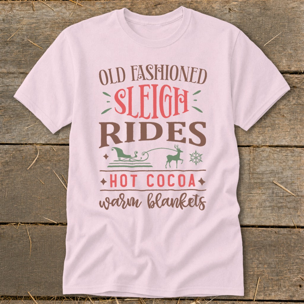 Light pink t-shirt with "Old Fashioned Sleigh Rides Hot Cocoa Warm Blankets" text.
