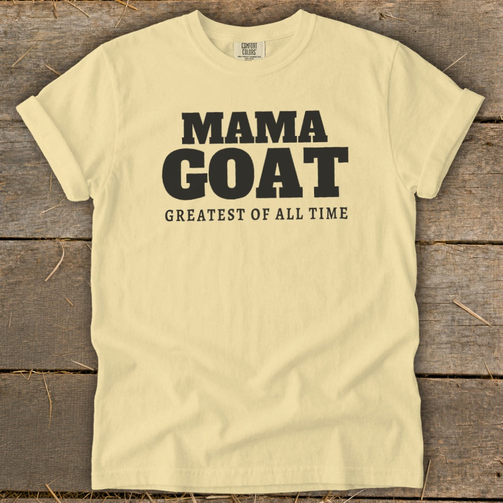 Light yellow t-shirt with black text "MAMA GOAT GREATEST OF ALL TIME".