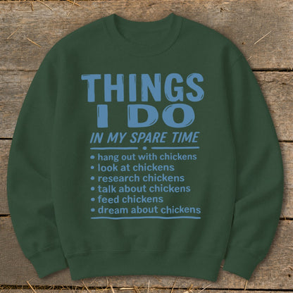 Green sweatshirt with blue text listing chicken-related activities.