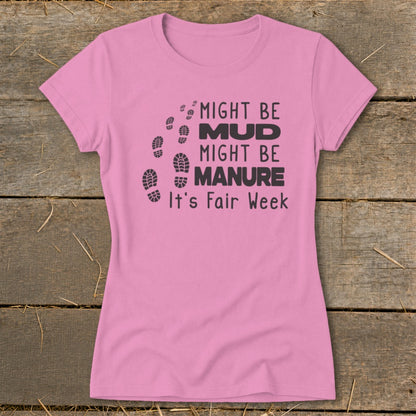 Pink t-shirt with "Might Be Mud, Might Be Manure, It's Fair Week" text and footprints.