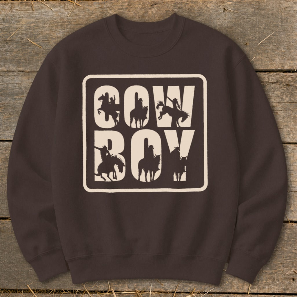 Brown crewneck sweatshirt with a cream-colored block graphic featuring "COW BOY" and horse silhouettes.