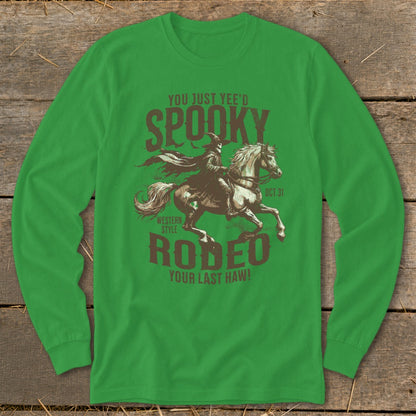 Green long-sleeve shirt with "Spooky Rodeo" text and cowboy riding horse graphic.
