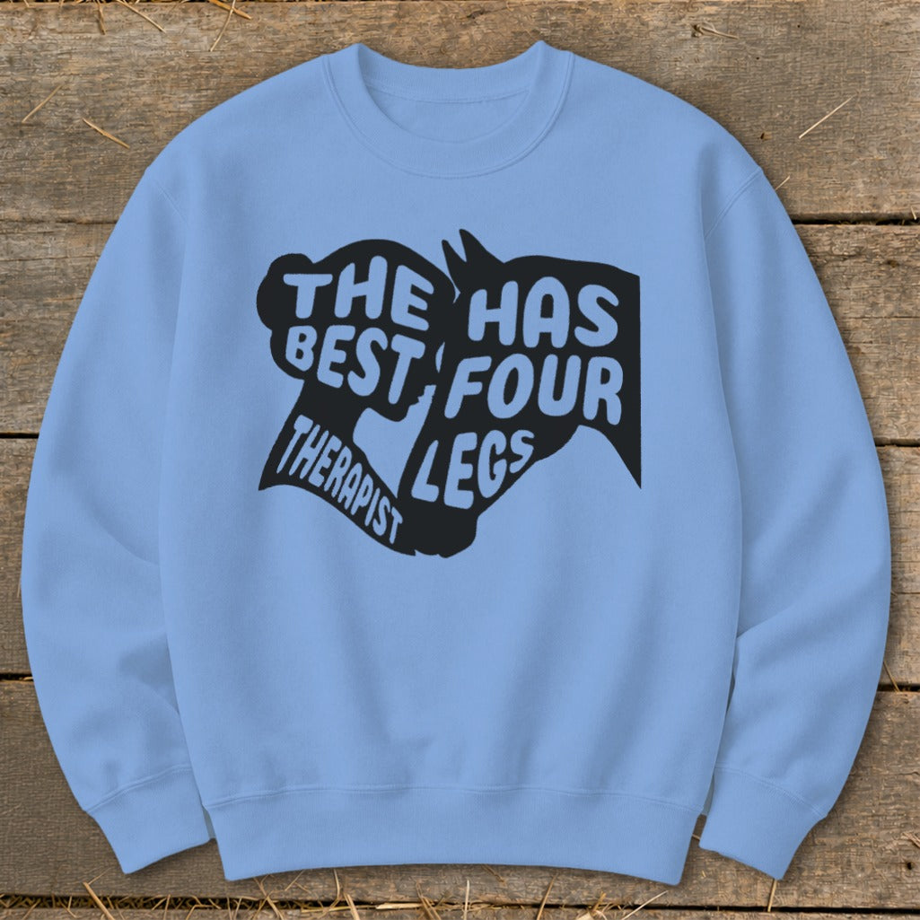 Light blue crewneck sweatshirt with black graphic text: "The best therapist has four legs."