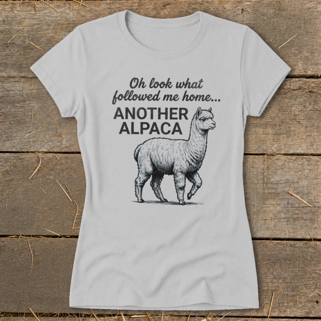 Light grey t-shirt with black text and alpaca graphic: "Oh look what followed me home... ANOTHER ALPACA"