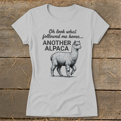 Light grey t-shirt with black text and alpaca graphic: "Oh look what followed me home... ANOTHER ALPACA"