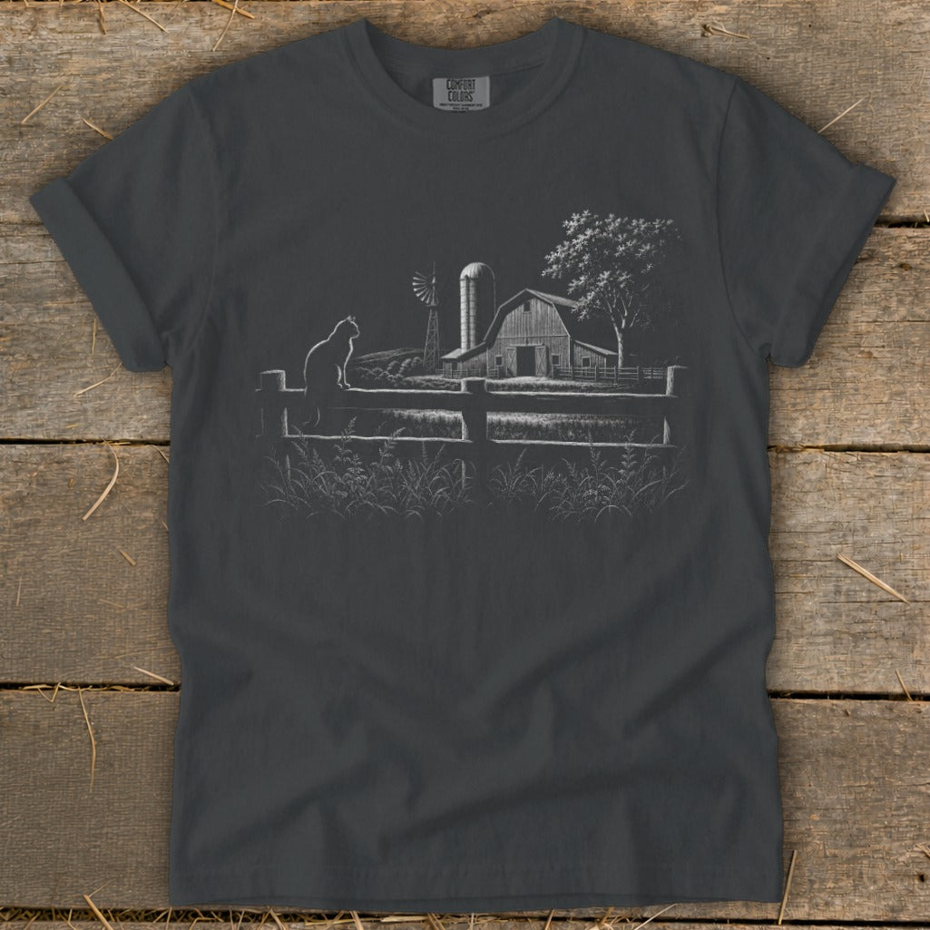 Dark grey t-shirt with a sketched farm scene, cat on fence, barn, windmill, and tree.