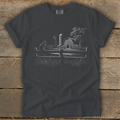 Dark grey t-shirt with a sketched farm scene, cat on fence, barn, windmill, and tree.