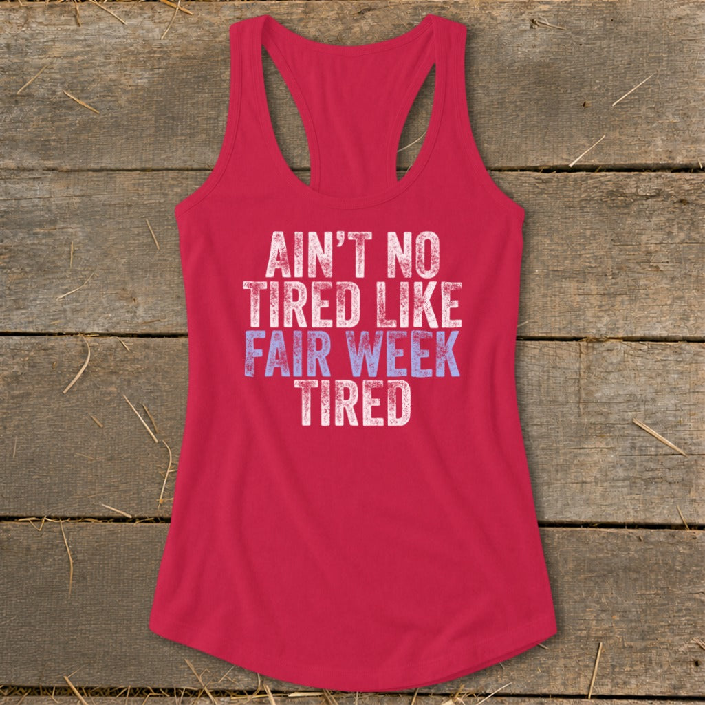 Red racerback tank top with "Ain't No Tired Like Fair Week Tired" graphic.