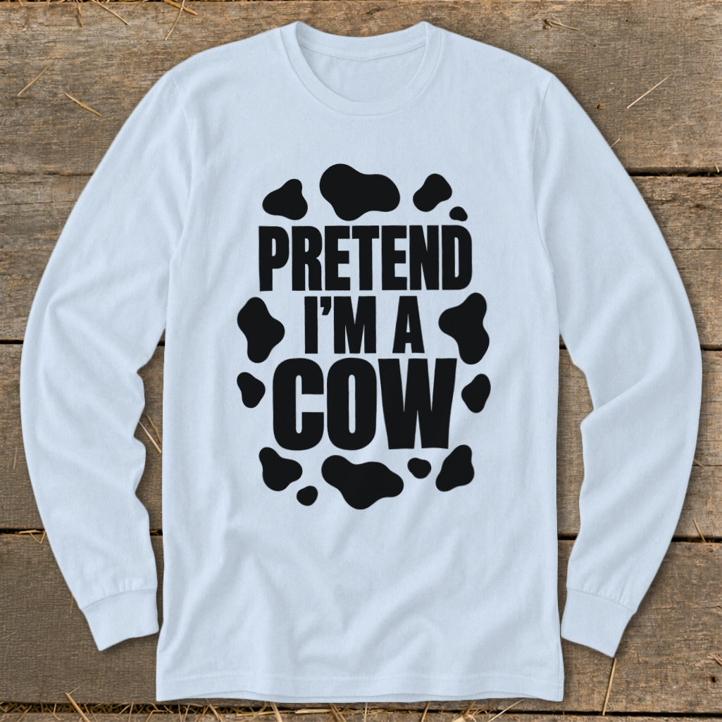 White long-sleeve shirt with black "PRETEND I'M A COW" text and cow spots.