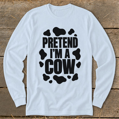 White long-sleeve shirt with black "PRETEND I'M A COW" text and cow spots.