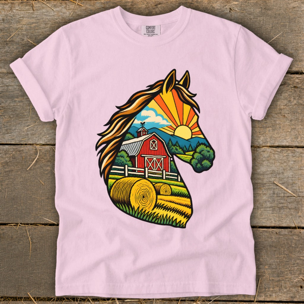 Light pink crewneck t-shirt featuring a colorful graphic of a horse head filled with a sunset farm scene.