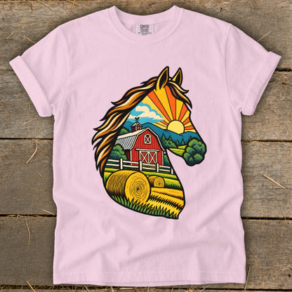 Light pink crewneck t-shirt featuring a colorful graphic of a horse head filled with a sunset farm scene.
