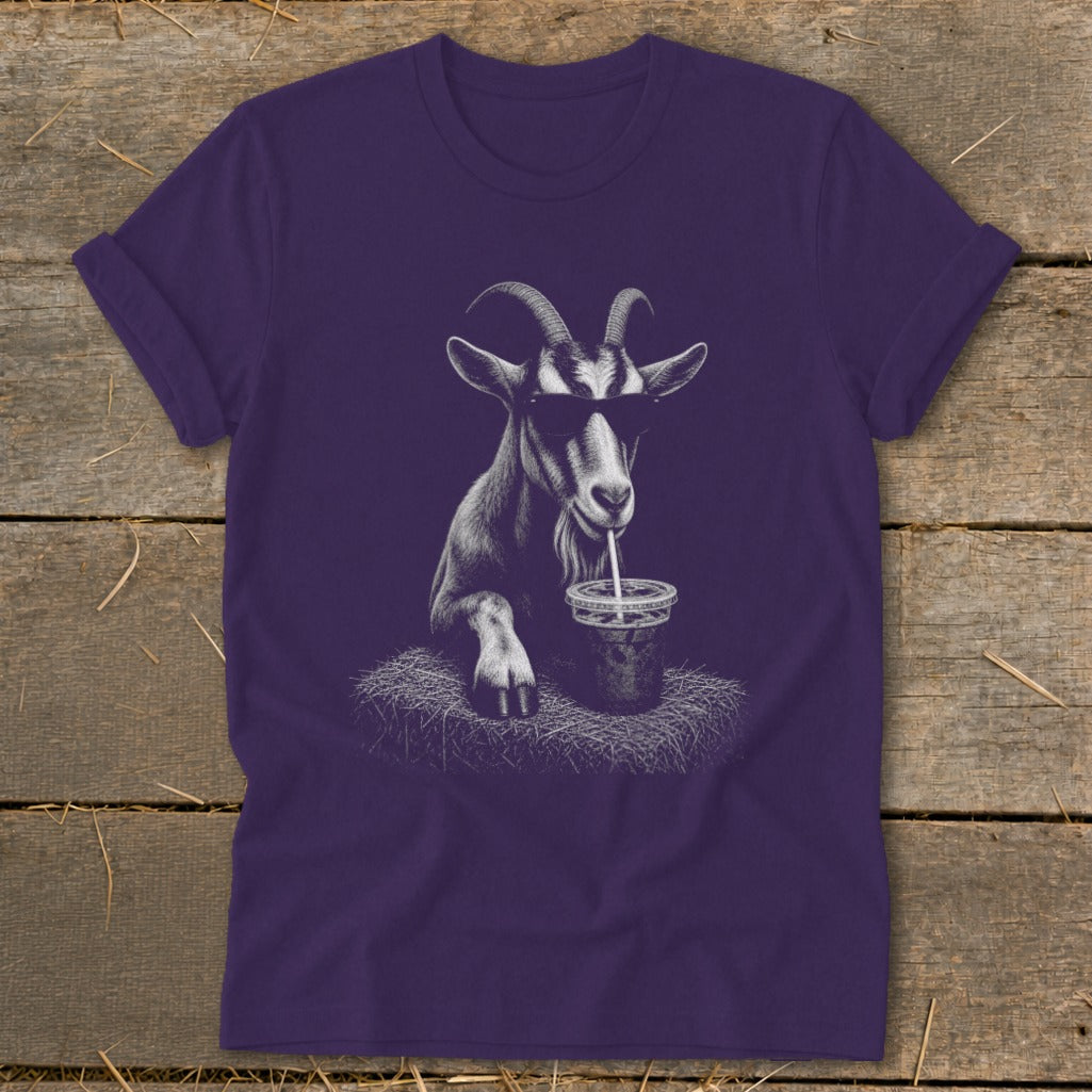 Goat wearing sunglasses drinks from a cup with a straw on a t-shirt.