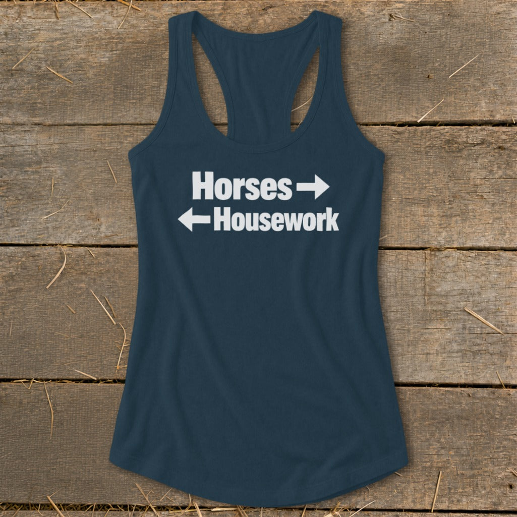 Dark blue women's racerback tank top featuring the white text "Horses" with a right arrow and "Housework" with a left arrow.